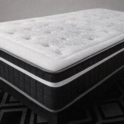 Colchón viscoelástico con tapa superior acolchada blanca de diseño capitoné y laterales en color gris oscuro, acabado premium para descanso confortable.